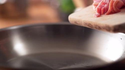 Diced Bacon Being Poured into Frying Pan