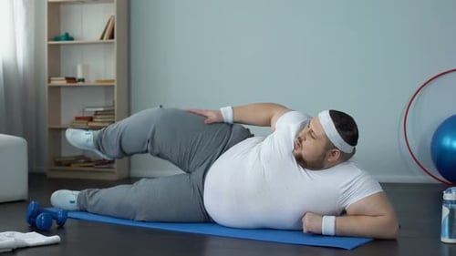 Man Doing Leg Lifts Exercise on Yoga Mat