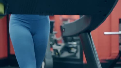 Close View Pretty Young Woman Runs on Treadmill in Gym