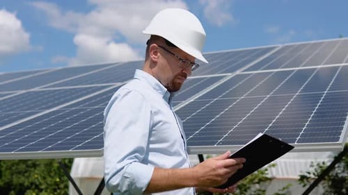 Engineers Checking Solar Panels with Tablet