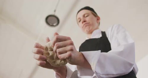 Woman Chef Kneading Dough in Kitchen