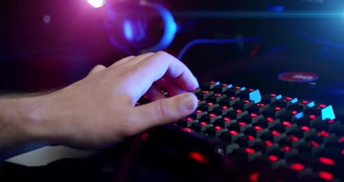 Close-up on the Hands of the Gamer Playing in the Video Game Using Keyboard Background with Cool