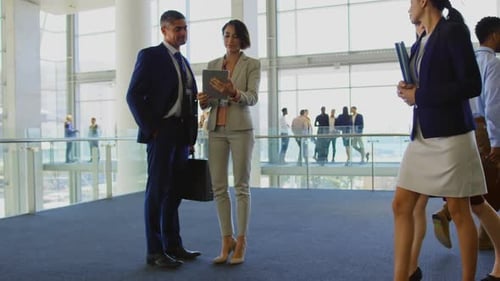 Business people discussing over digital tablet in the office 4k