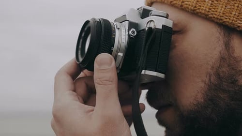 Close-up Happy European Photographer Man Taking Picture with Retro Style Film Camera on Overcast