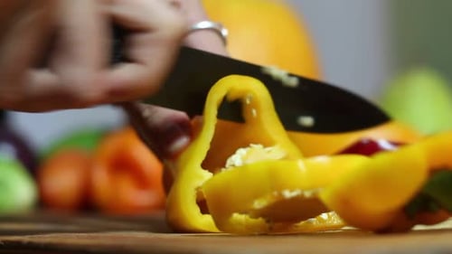Cutting a Yellow Bell Pepper on Cutting Board