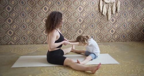 Woman and Child Practicing Yoga at Home