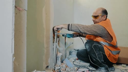 A Builder Plumber Lays Water Pipes in a Bathroom During Renovations in a House