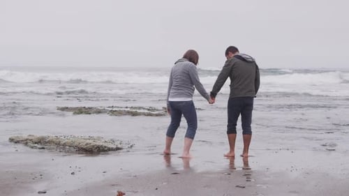 Couple walking at beach together. Shot on RED EPIC for high quality 4K, UHD, Ultra HD resolution.