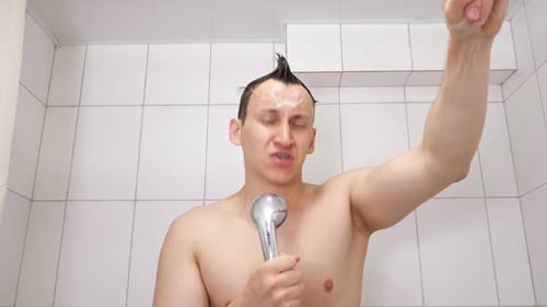 Man Singing into Shower Head in Bathroom