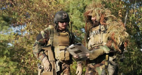 Soldiers Discuss Tactical Plan in Camouflage