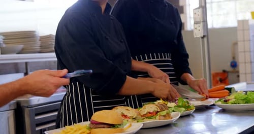 Chefs Prepare Food in Busy Restaurant Kitchen