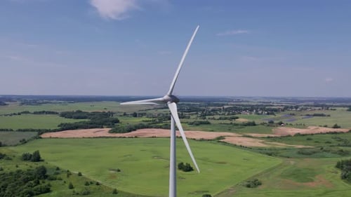 Aerial view of windmills farm for energy production on beautiful cloudy sky at highland. Wind power