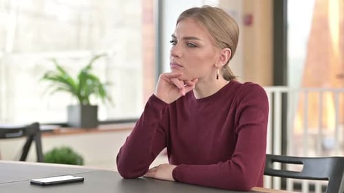 Pensive Young Woman Thinking in Office Thoughts
