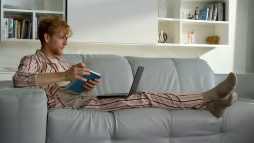 Freelancer Making Notes Browsing Web on Weekend