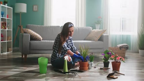Woman Gardening with Potted Plants on Living Room Floor