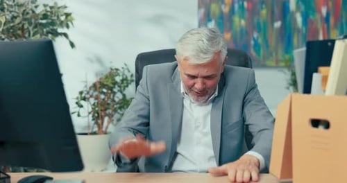 Senior Man Celebrating at His Office Workplace