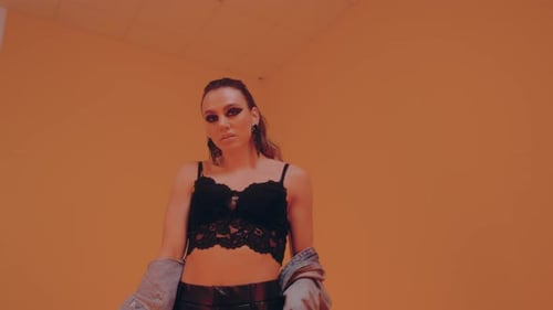 Stylish Young Adult Posing Against a Blank Wall