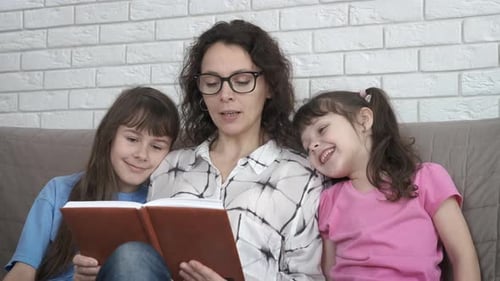 Mother Reading to Children at Home