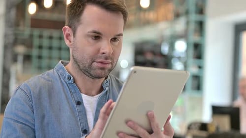 Man Uses Tablet in Modern Office Setting