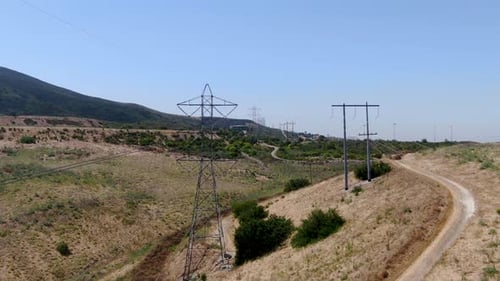 Aerial View of Electricity Transmission Pylon in Dry Valley Landscape