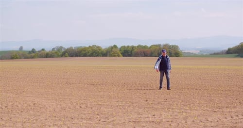 Agriculture Farmer Walking on Field.