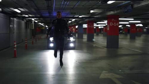 Young Adult Runs in Dark Parking Garage