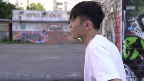 Young Adult Performs Hand Motions in Skate Park