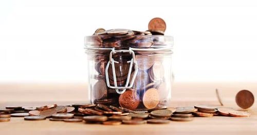 Close-up of coins falling in bottle