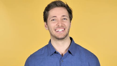 Man Laughing and Smiling Against Yellow Background
