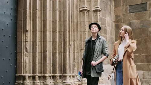 Young Couple Walking By Old Buildings in City