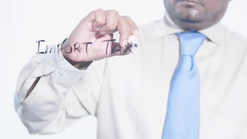 Asian Businessman Writes Import Taxes