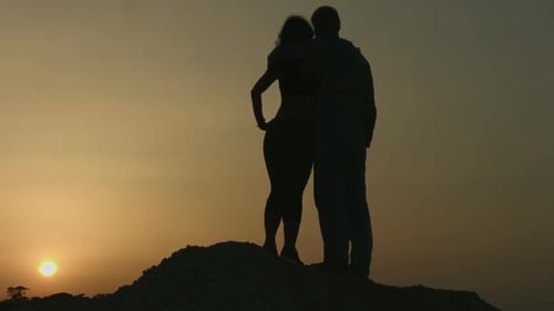 Romantic Couple Embracing at Sunset Silhouette