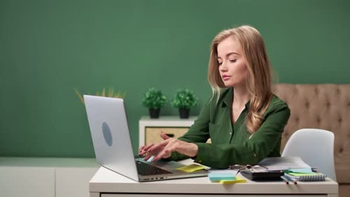 Confident Young Business Woman Working at Home Office Using Laptop
