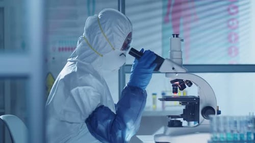 Scientist Works With Microscope in Bright Laboratory