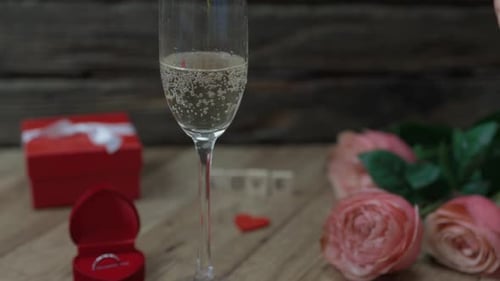 Champagne, Roses, and Ring Ready for Celebration