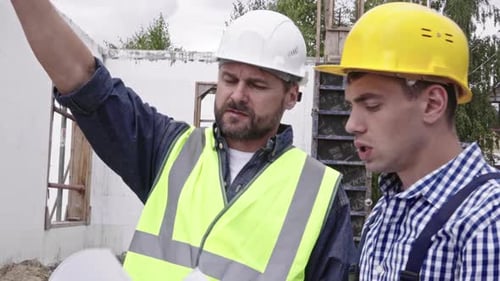 Construction Workers Planning New Project on Building Site