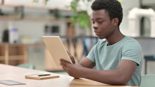 Man Using Tablet at Desk Indoors
