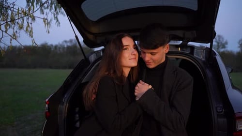 Loving Couple Embracing by Car in the Countryside