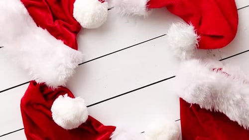 Festive Santa Hats on White Wooden Surface