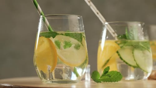 Refreshing Lemon and Mint Infused Water Being Poured