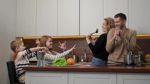 Fun Family Singing and Dancing in Kitchen