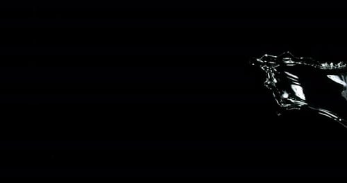 Water Flowing Across Frame on Black Background