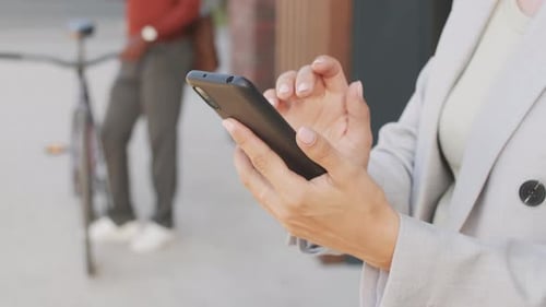 Woman Using Mobile Phone in Urban Setting