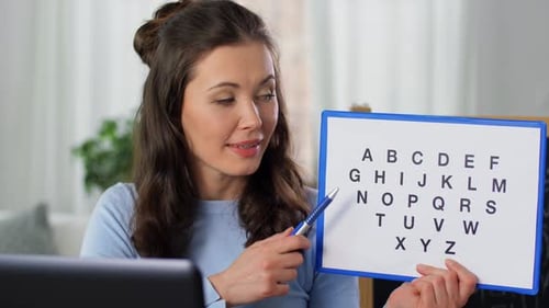 Woman Teaching Alphabet Online at Home