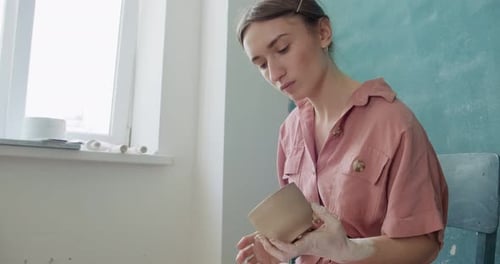 Woman Handcrafting Clay Pottery at Studio