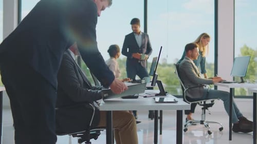 Diverse Office Workers Collaborate in Modern Workplace