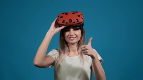 Woman with Virtual Reality Glasses on Head Shows Thumb Up