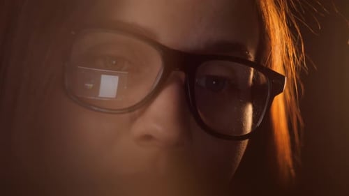 Close Up of Tired Woman Working at Night on Laptop Girl in Eye Glasses with Reflections Overworking