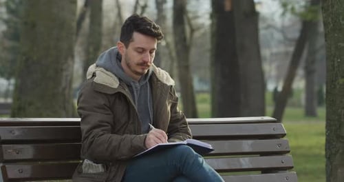 Man writing in a notebook