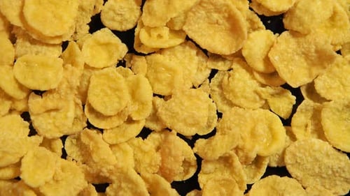 Crunchy Cornflakes Cereal Close-Up on Black Surface
